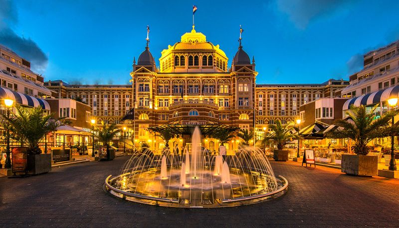 The grand, historic facade of the Kurhaus Hotel in Scheveningen